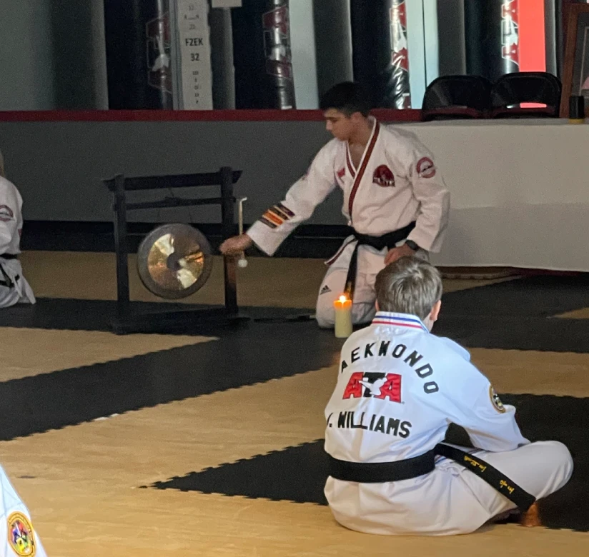 Adult martial arts instructor coaching student with focus mitts during fitness training in Angola gym