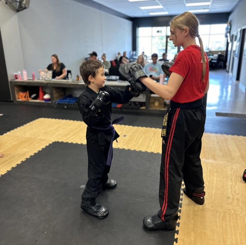 kids practicing martial arts in Angola, building confidence, focus, and discipline through martial arts training.